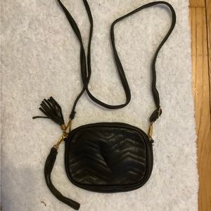 A black long strap shoulder purse.